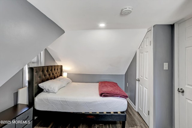 bedroom featuring vaulted ceiling and wood finished floors