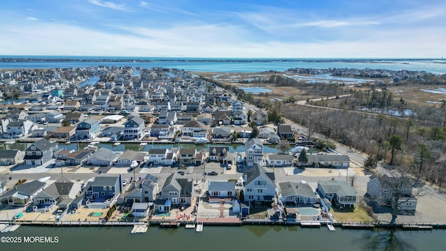 drone / aerial view with a water view and a residential view