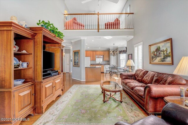 living area featuring ceiling fan and a towering ceiling