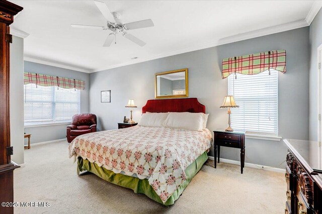 carpeted bedroom with baseboards, ornamental molding, and a ceiling fan