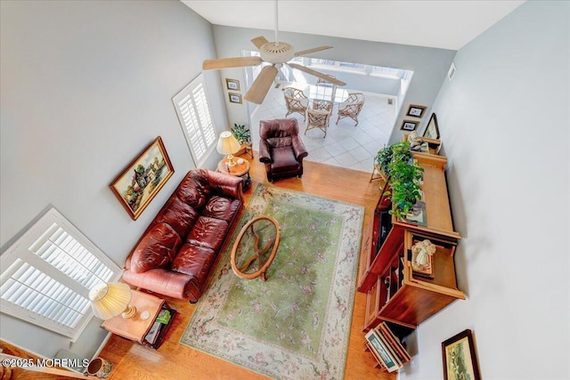 living room featuring lofted ceiling and ceiling fan