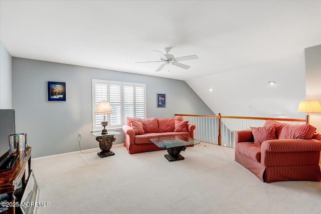 carpeted living room featuring baseboards, a ceiling fan, and vaulted ceiling