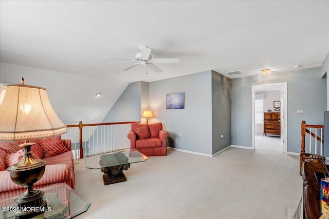 carpeted living area with visible vents, baseboards, and a ceiling fan