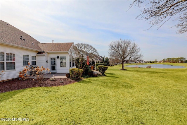 view of yard with a patio and a water view