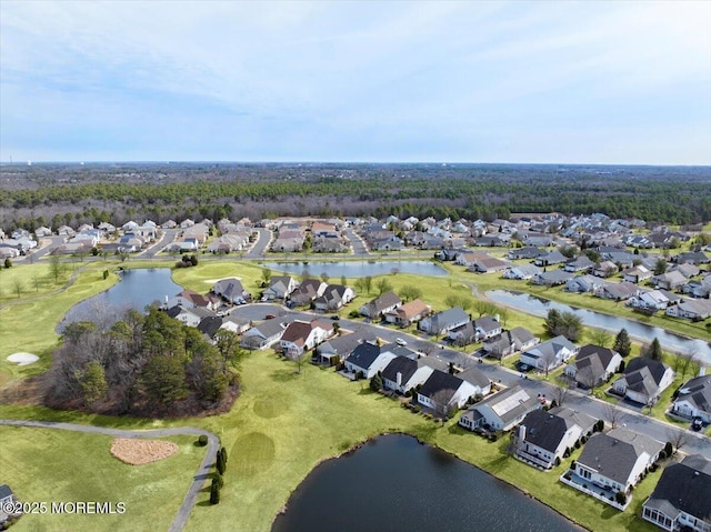 drone / aerial view featuring a residential view and a water view