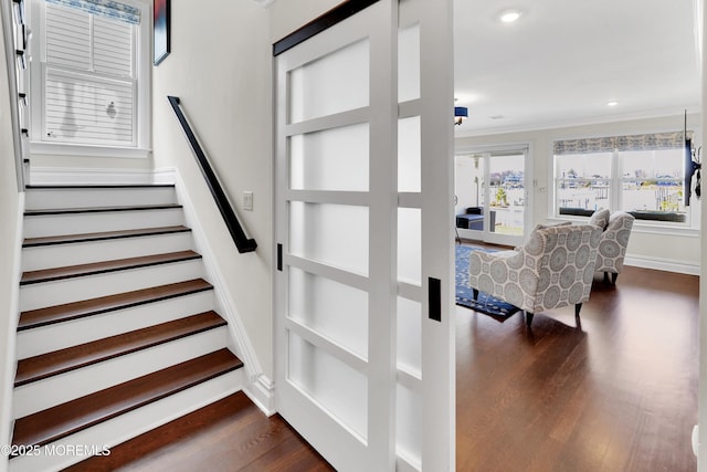 staircase featuring crown molding, recessed lighting, wood finished floors, and baseboards