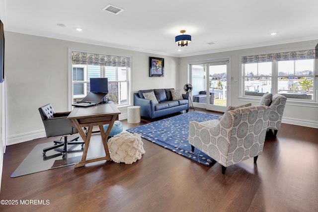 living room featuring wood finished floors, visible vents, and a wealth of natural light