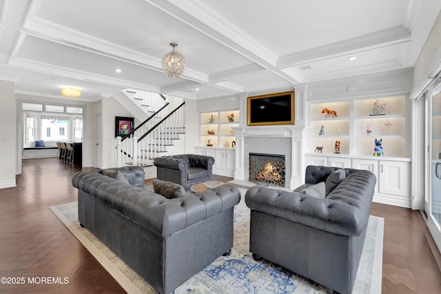 living area featuring built in shelves, coffered ceiling, a fireplace with flush hearth, stairs, and beamed ceiling