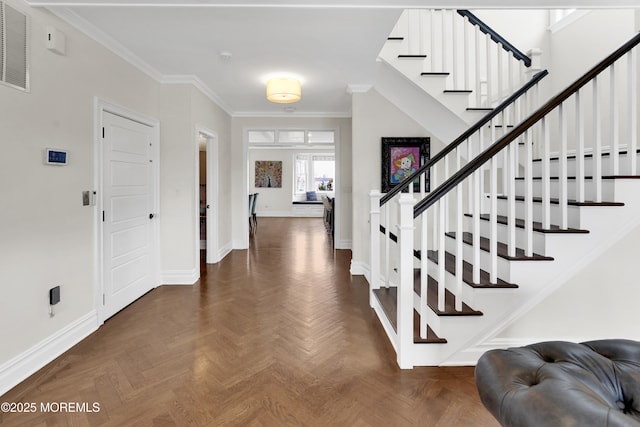 foyer entrance featuring stairs, visible vents, baseboards, and ornamental molding