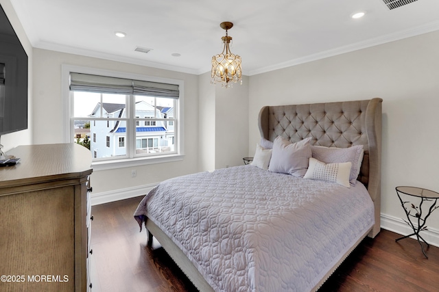 bedroom featuring visible vents, dark wood-style flooring, baseboards, and ornamental molding