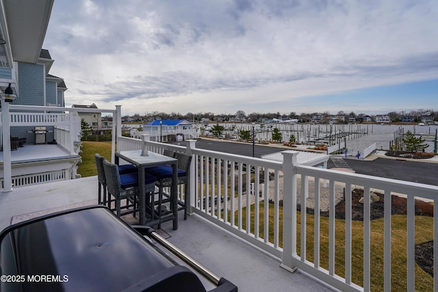 balcony featuring a residential view, a grill, and a dock