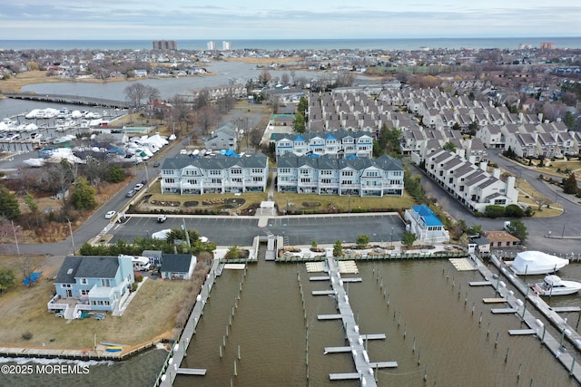 drone / aerial view featuring a residential view and a water view