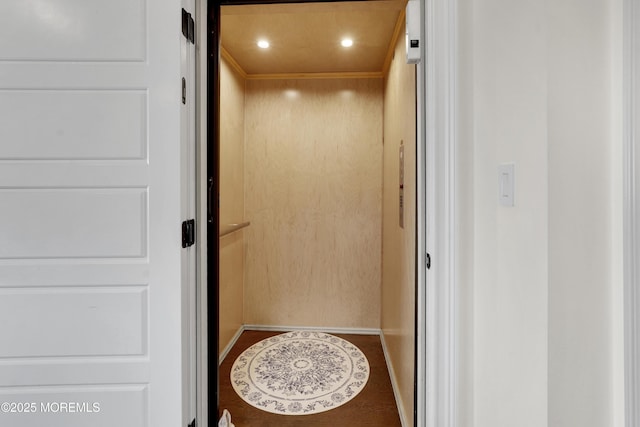 room details featuring elevator, recessed lighting, baseboards, and wood finished floors