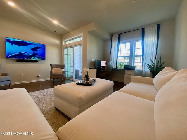 living area with recessed lighting, baseboards, and wood finished floors