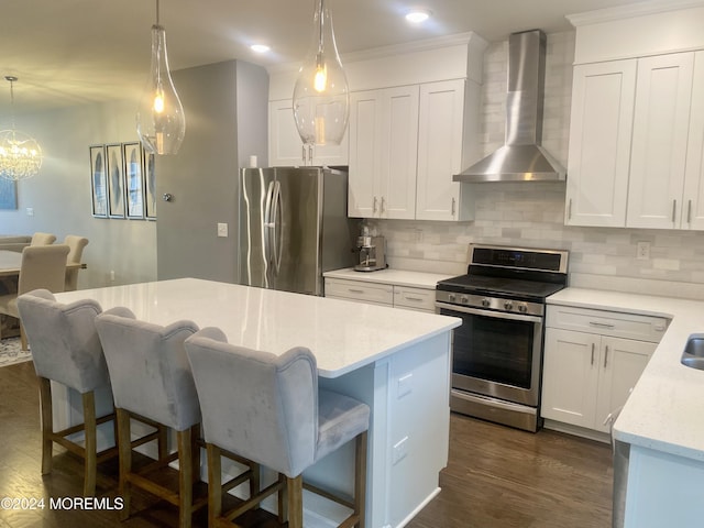 kitchen featuring decorative backsplash, wall chimney exhaust hood, dark wood-style floors, and appliances with stainless steel finishes