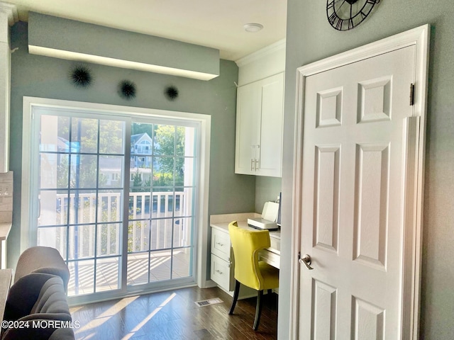 home office featuring visible vents, dark wood-style flooring, and crown molding