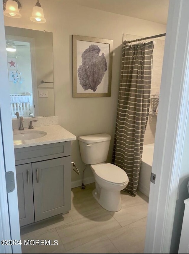 full bathroom with toilet, shower / bath combo, and vanity