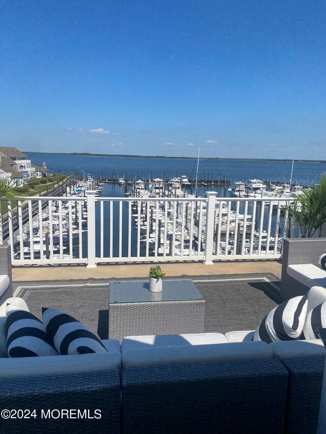 view of patio / terrace featuring a water view and a balcony