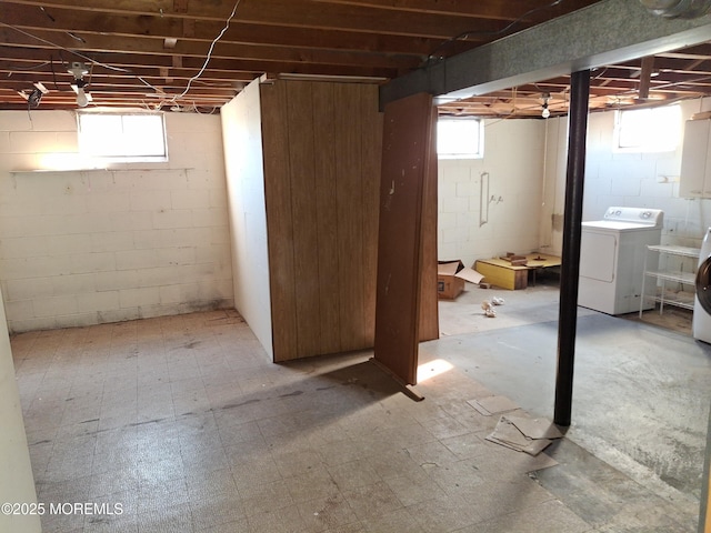 basement featuring washer / dryer, a healthy amount of sunlight, and tile patterned floors