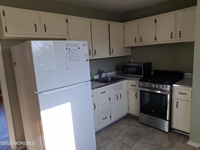 kitchen with white cabinets, stainless steel appliances, and a sink