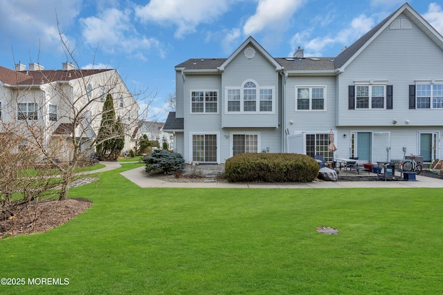 back of property with a patio and a lawn