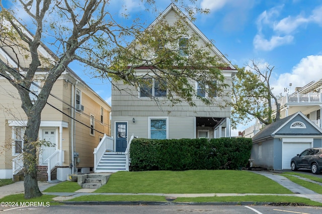 view of front of property featuring a garage and a front lawn