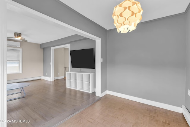 unfurnished room featuring baseboards, an AC wall unit, ceiling fan with notable chandelier, parquet floors, and a baseboard radiator