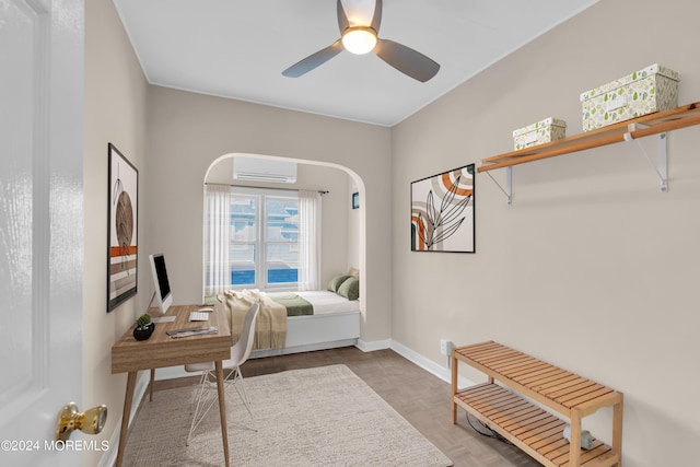 bedroom featuring a wall mounted air conditioner, baseboards, and ceiling fan