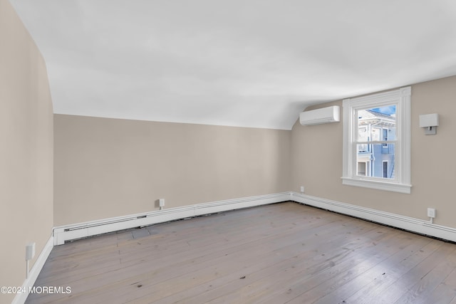 additional living space featuring a baseboard radiator, a wall mounted air conditioner, lofted ceiling, and wood-type flooring