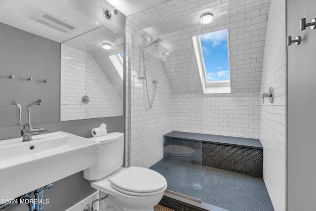 bathroom with tiled shower and toilet