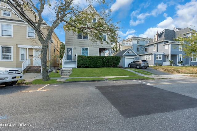 view of property with a residential view, uncovered parking, and a front yard