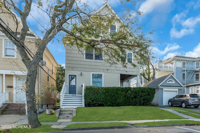 view of front of property with a garage and a front lawn