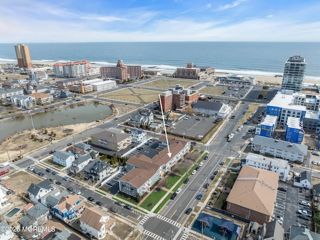 drone / aerial view featuring a water view and a view of city