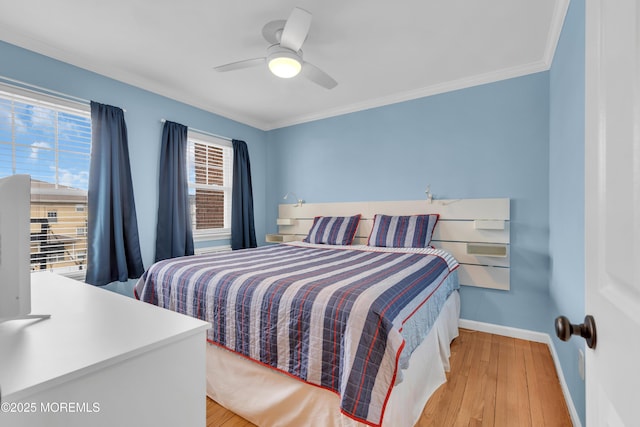 bedroom with a ceiling fan, baseboards, light wood-style floors, and crown molding