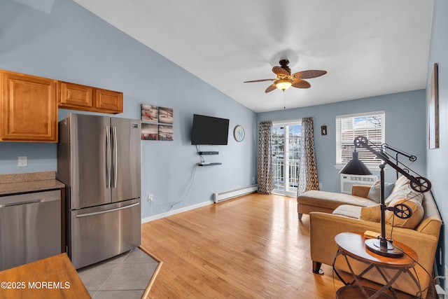 living room with light wood-style flooring, a baseboard radiator, baseboards, ceiling fan, and vaulted ceiling