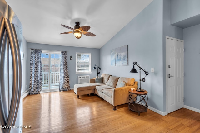 living room with light wood finished floors, a baseboard heating unit, baseboards, ceiling fan, and a wall mounted AC