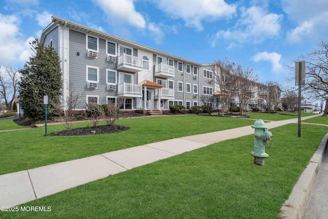 view of home's community featuring a lawn and a residential view