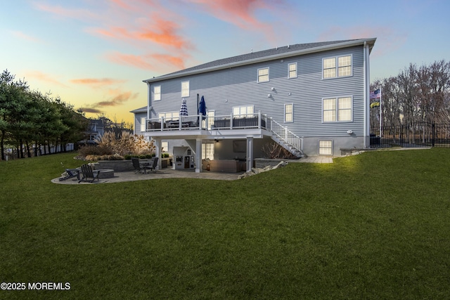 back of property featuring fence, a yard, stairs, a deck, and a patio area