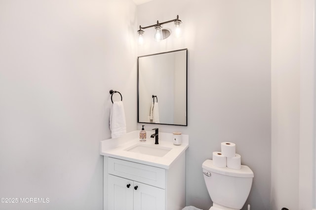 bathroom with toilet and vanity