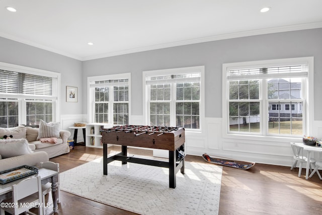 game room with crown molding, recessed lighting, dark wood-style floors, and wainscoting