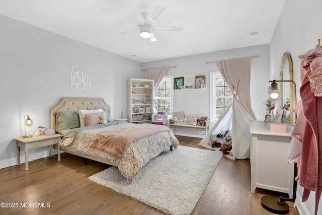 bedroom featuring baseboards, ceiling fan, and wood finished floors