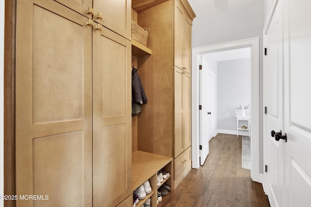 mudroom featuring dark wood-style floors and baseboards