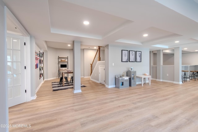 finished below grade area with recessed lighting, stairway, baseboards, and light wood finished floors