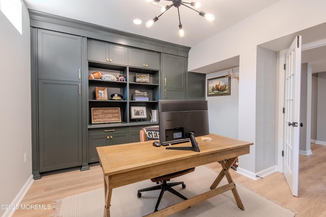 office with french doors, baseboards, and light wood finished floors