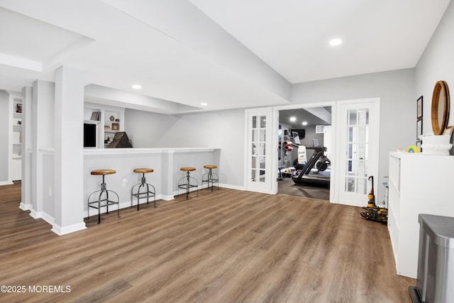 interior space with recessed lighting, french doors, baseboards, and wood finished floors