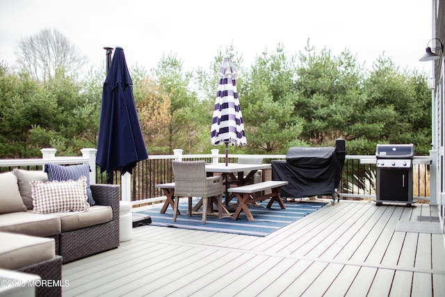 wooden deck featuring outdoor dining space and grilling area