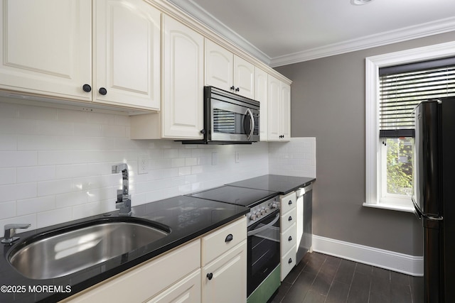 kitchen with stainless steel appliances, baseboards, decorative backsplash, and a sink