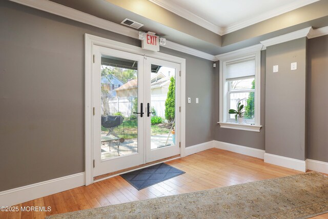 doorway featuring baseboards, ornamental molding, french doors, and hardwood / wood-style flooring