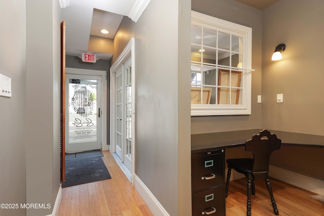 foyer with baseboards and light wood-type flooring
