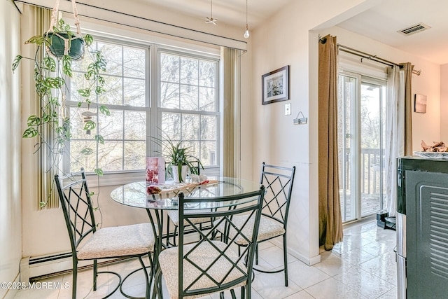 dining area featuring light tile patterned floors, baseboards, and visible vents